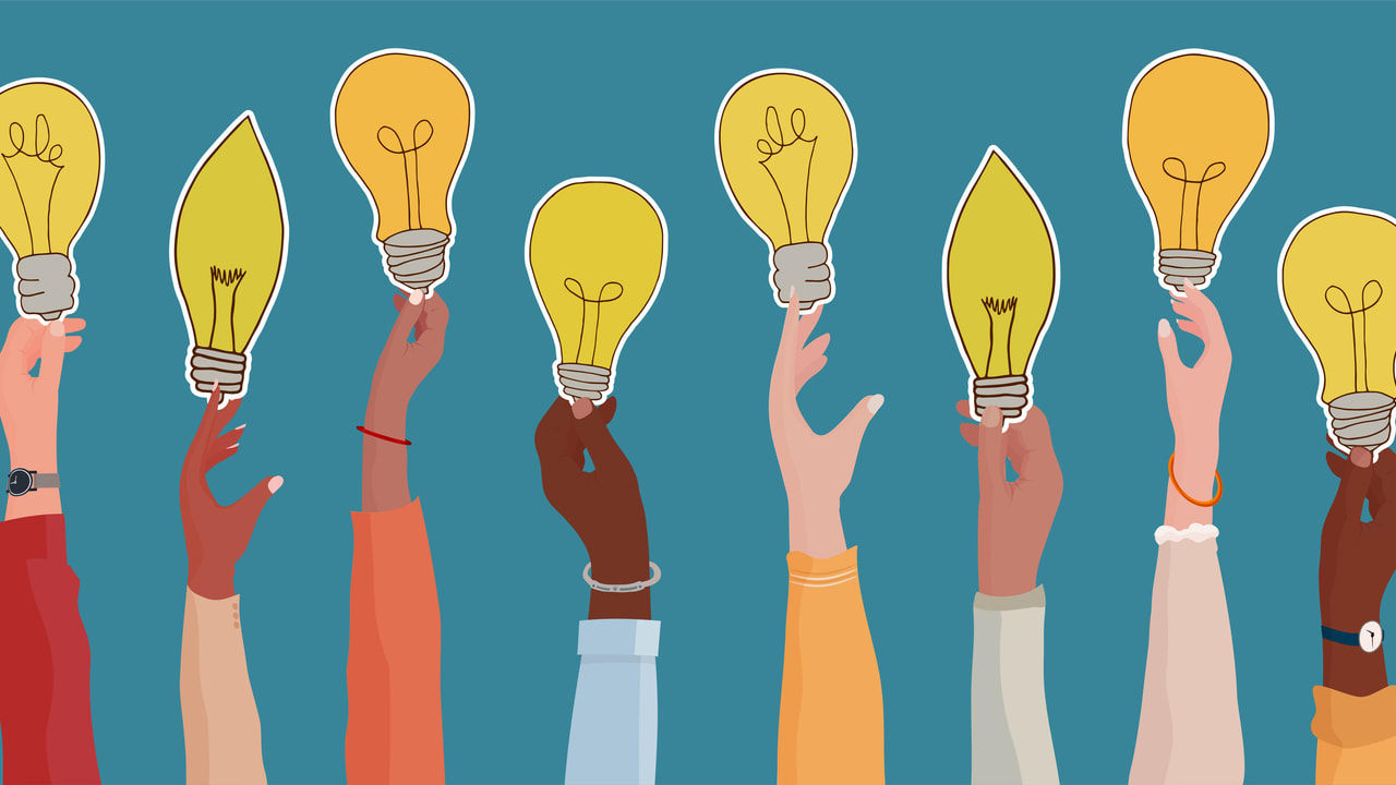 A group of hands holding up light bulbs.