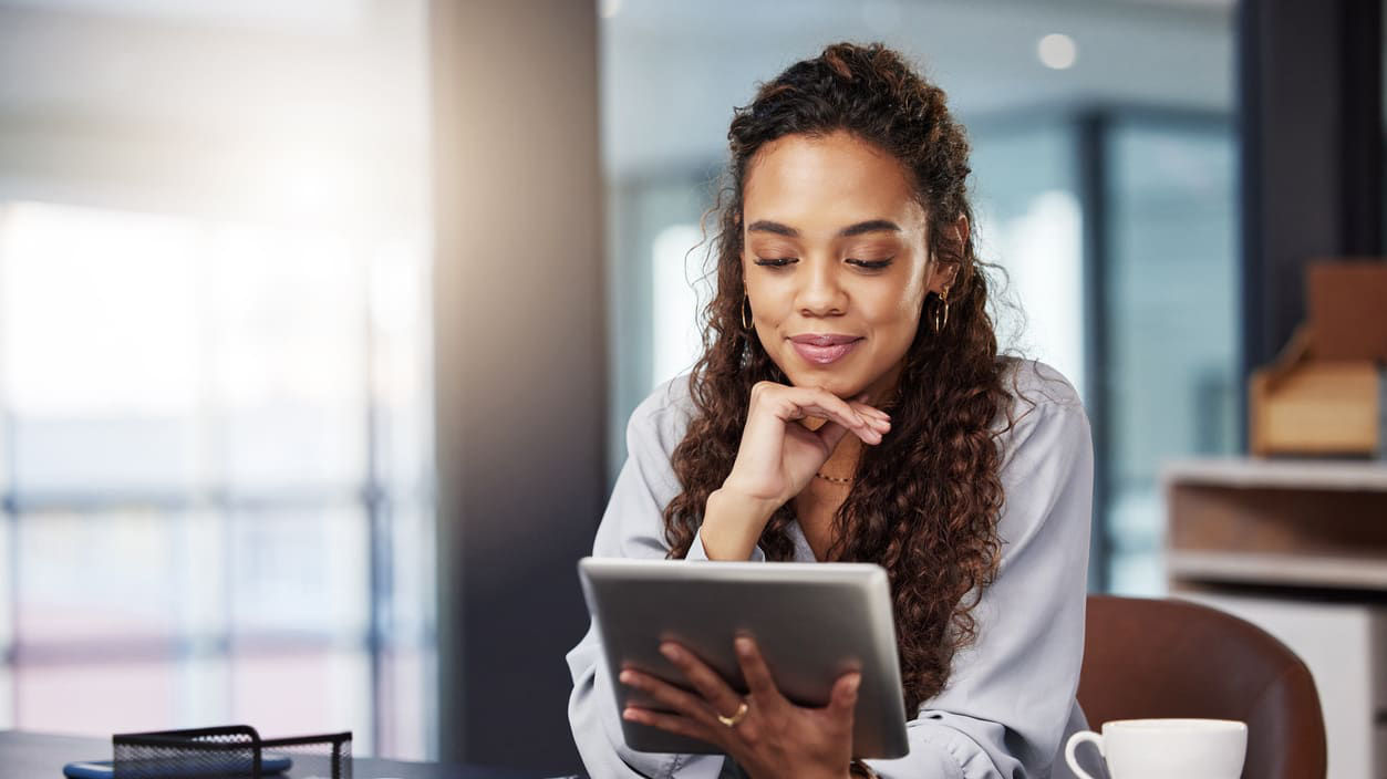A business woman using a tablet computer in an office.
