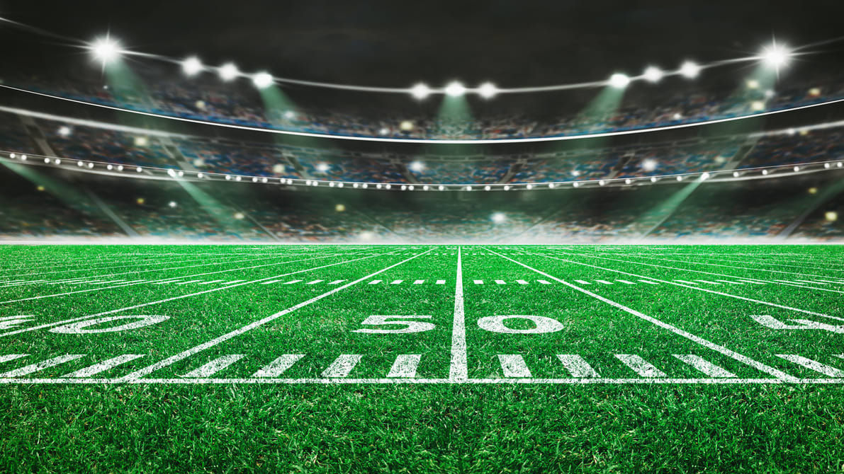 An american football field with lights on it.