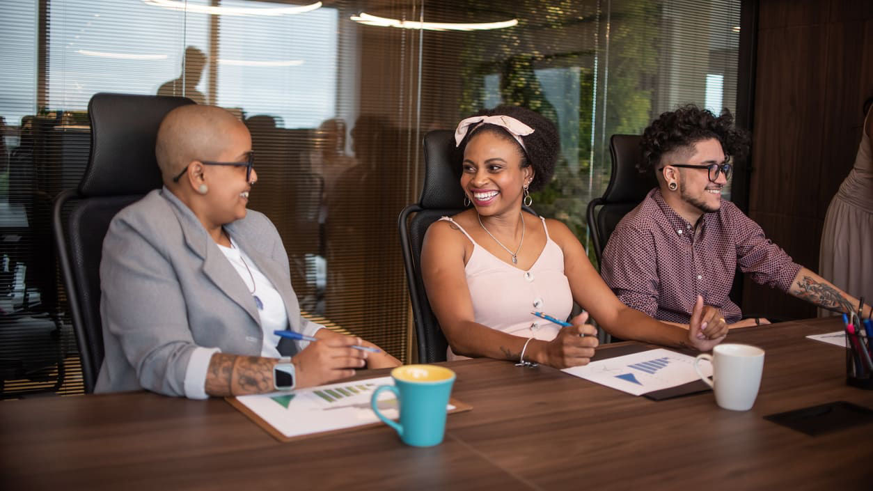 A group of people sitting at a conference table.