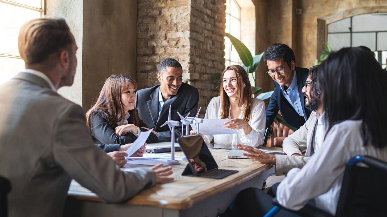 A group of business people sitting around a table.