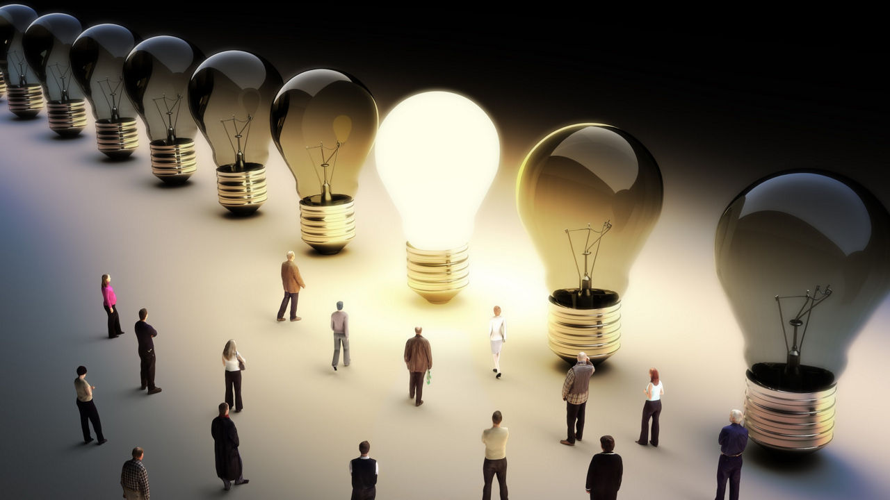 A group of people standing in front of light bulbs.