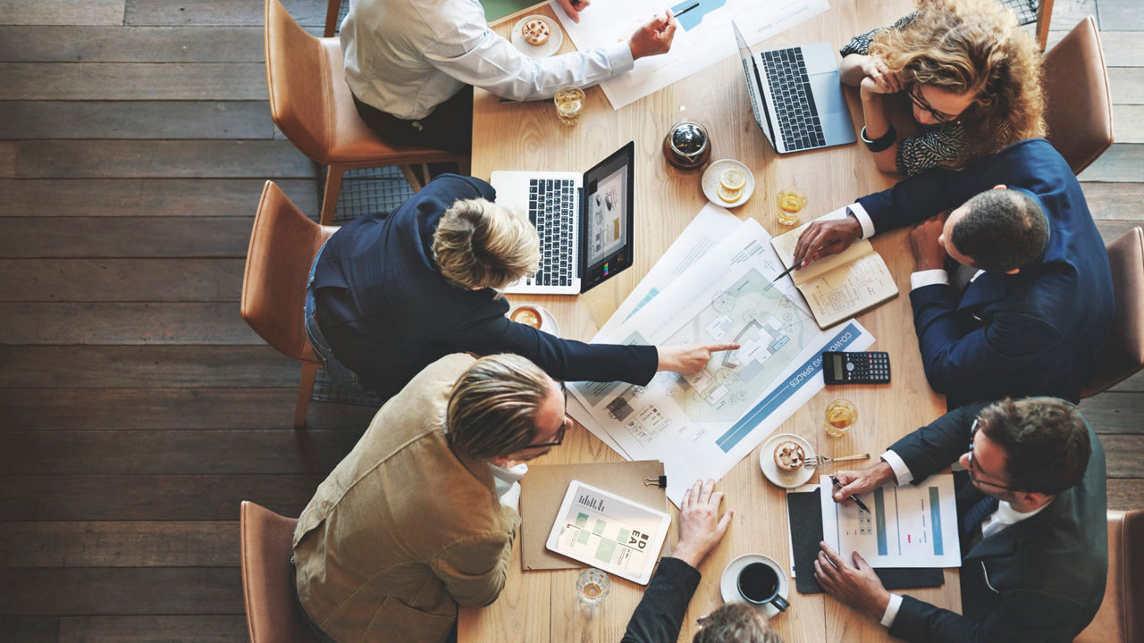 A group of business people sitting around a table.