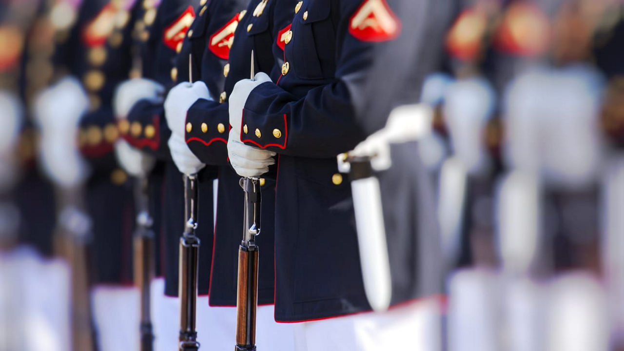 A group of marines in uniform standing in a line.