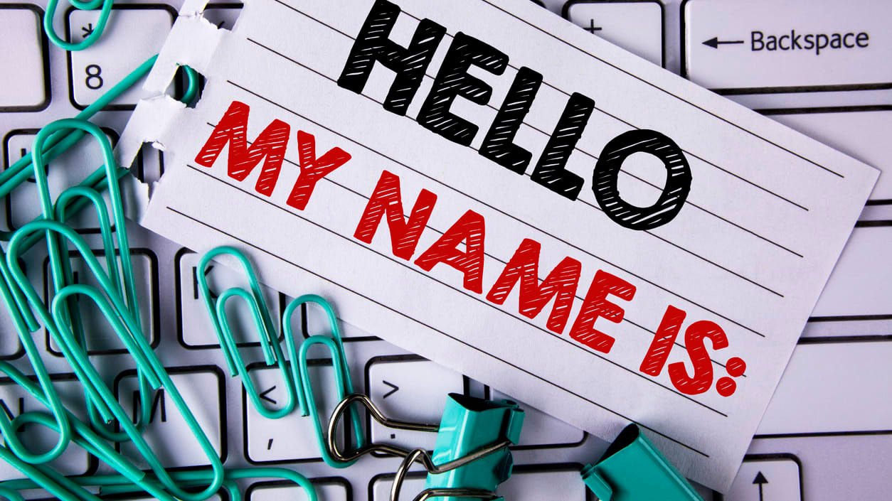 Hello my name is written on a piece of paper next to a keyboard.