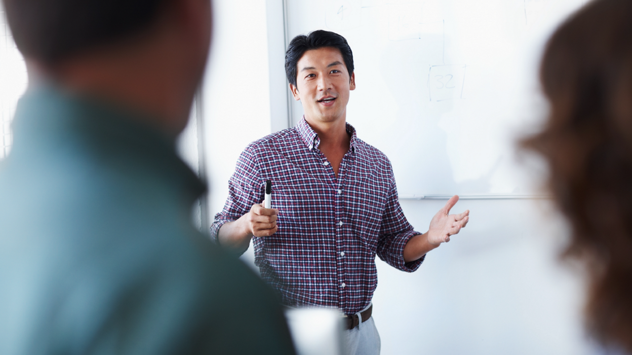 A man centered between two people talking