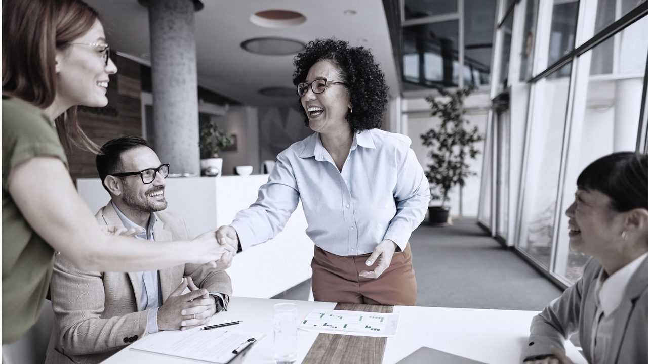 female executives shaking hands