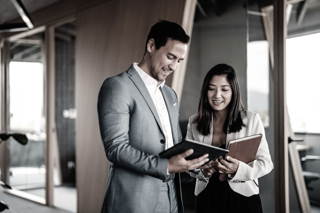 Business man and woman in office hallway