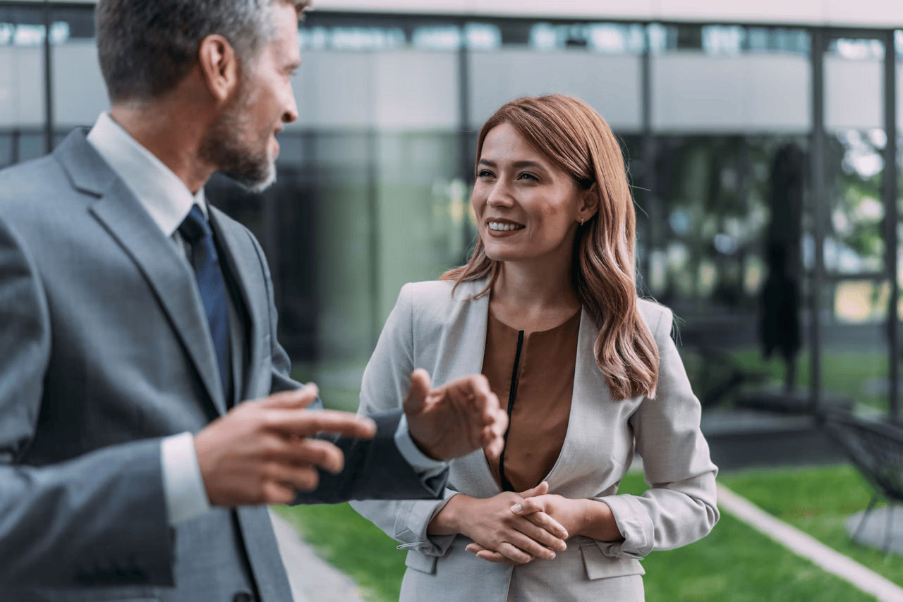 Two business people having a discussion outside.