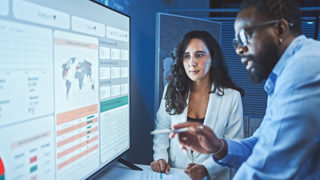 A team of multiethnic developers is meeting to review the data analysis of marketing from social media platforms.