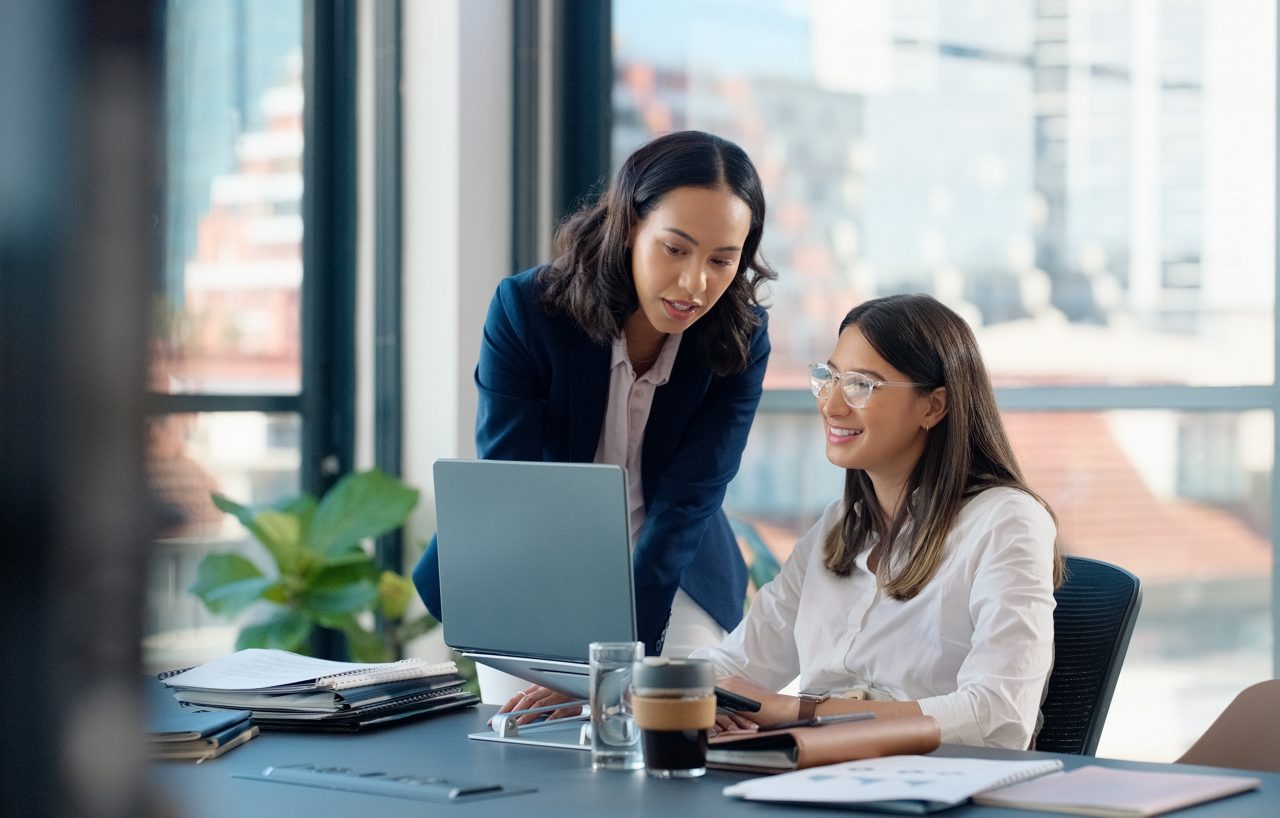 Business people, laptop or learning in training in discussion or conversation for news, education or advice. Teamwork, woman coaching or leader talking for online data or new job in digital agency