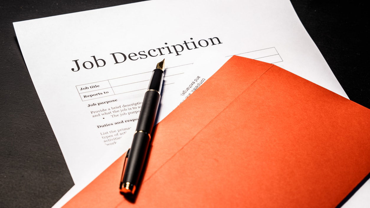 A job description on an envelope with a pen.