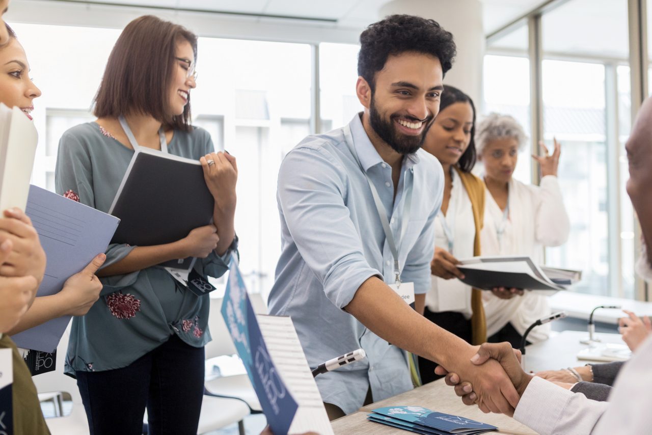 man shaking hands at job fair