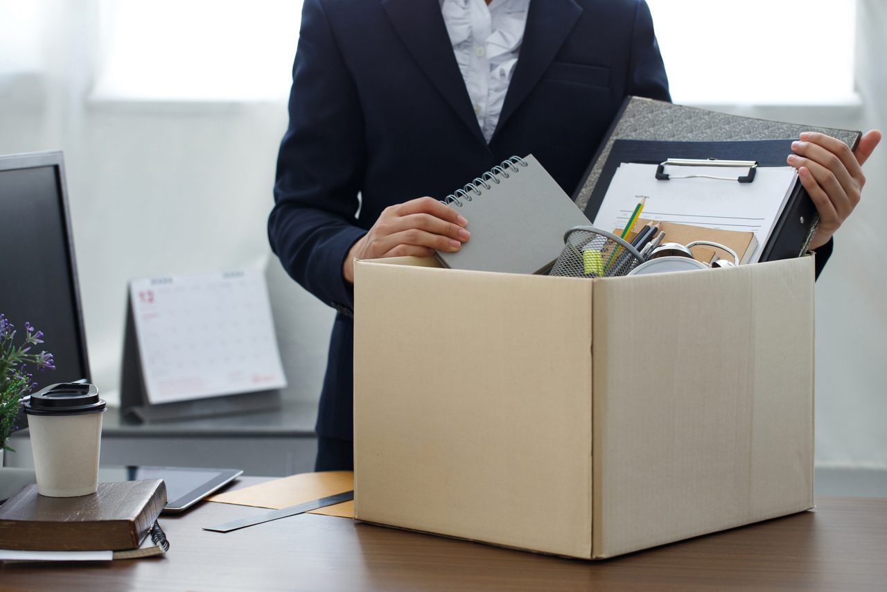 Businesswoman packs personal belongings as she leaves her job