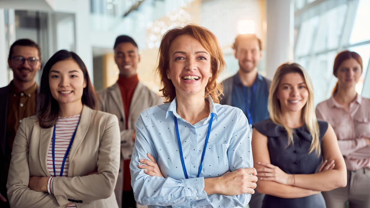 A group of business people standing in front of a building.
