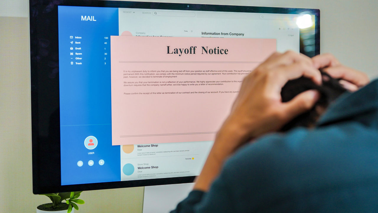 Frustrated fired man reading bad news in pink slip e-mail letter from laptop at home, Company got serious financial problems because  economic recession,corporate downsizing ,she was laid off quitting job Unemployment concept