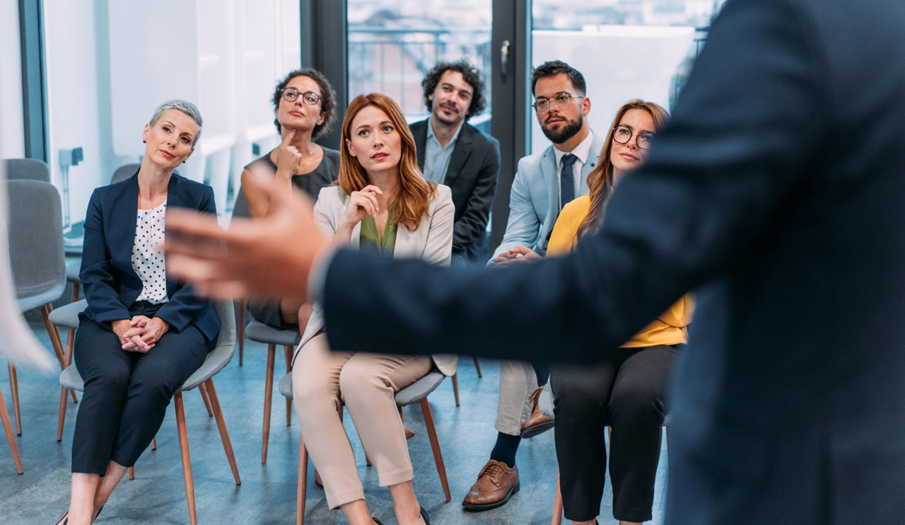 Shot of a businessman delivering a speech during a meeting in conference room. Businessman leading a training class for professionals. Businessman talking on seminar in front of his colleagues. Group of business persons in business meeting. Group of entrepreneurs on meeting in board room. Creative business team on meeting in the office. Shot of a businessman delivering a speech during a conference. Happy business leader talking to group of businesspeople on a seminar in conference hall.