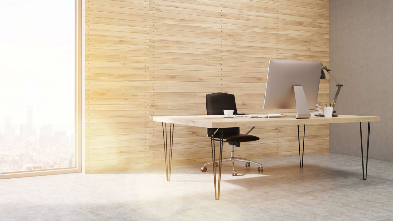 An office with wooden walls and a window overlooking a city.