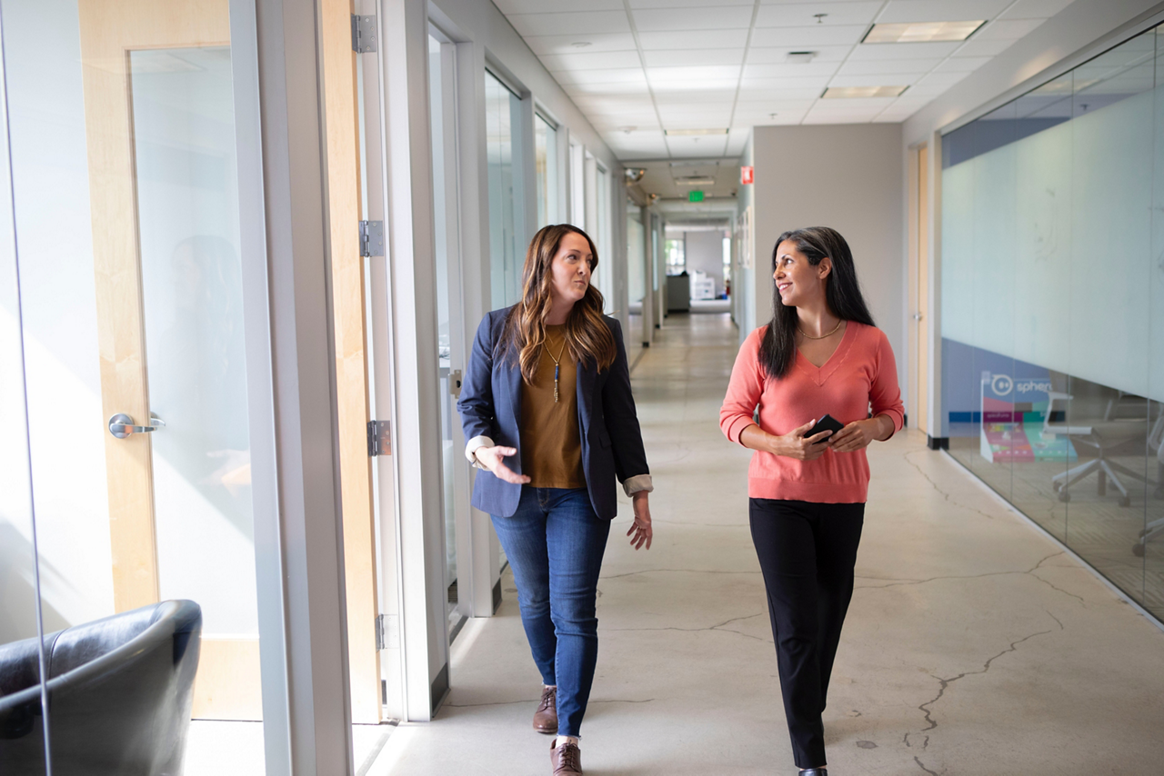 Team members walking in hallway and talking
