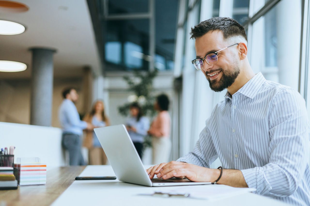 A focused executive is working diligently on a laptop, highlighting commitment, professional occupation, and managerial responsibilities in the corporate business setting