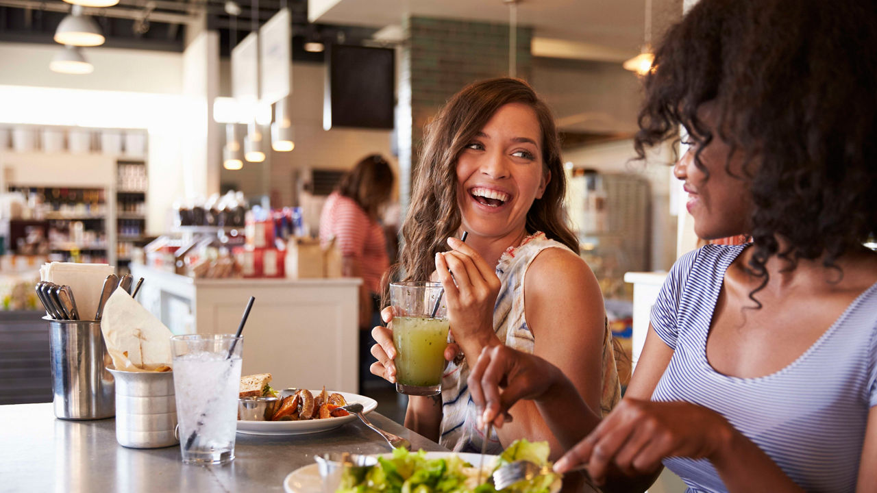 Two women eating at a restaurant.