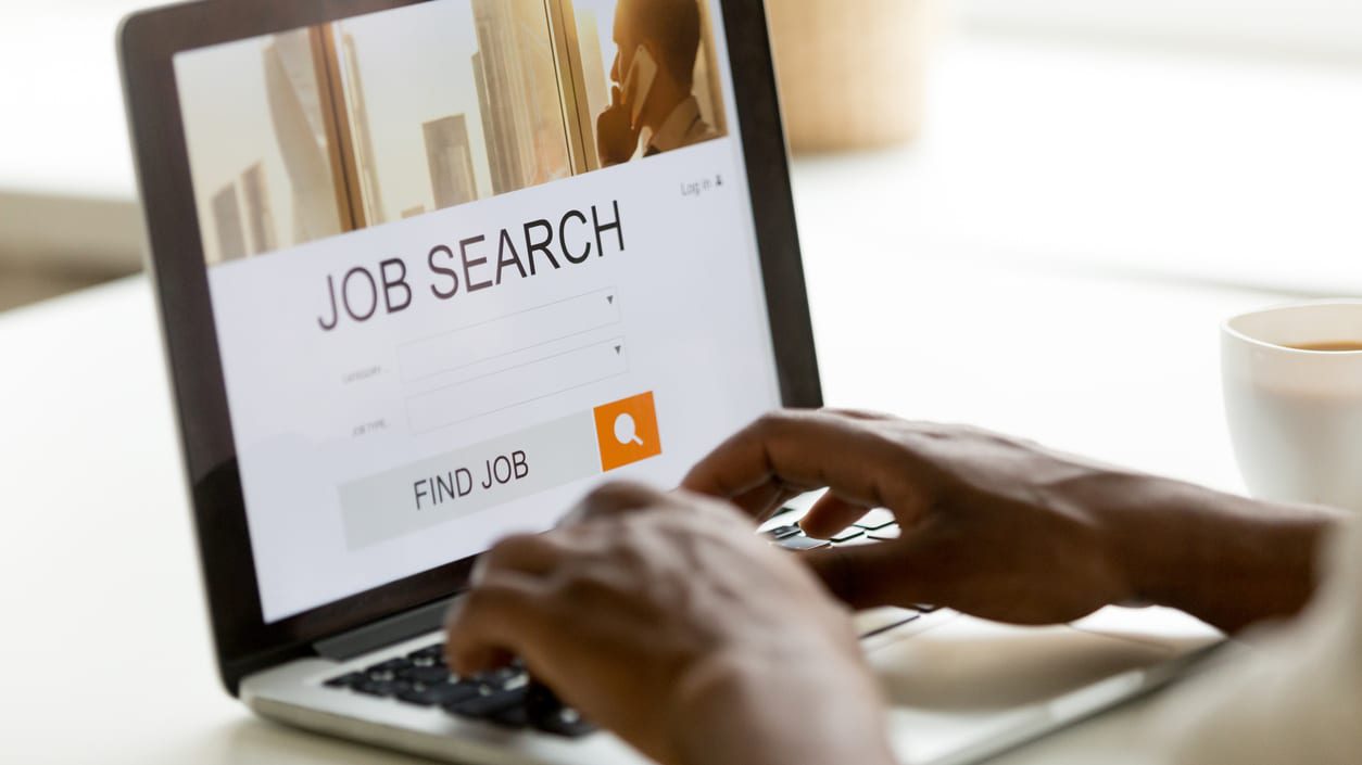 A person using a laptop to search for a job.