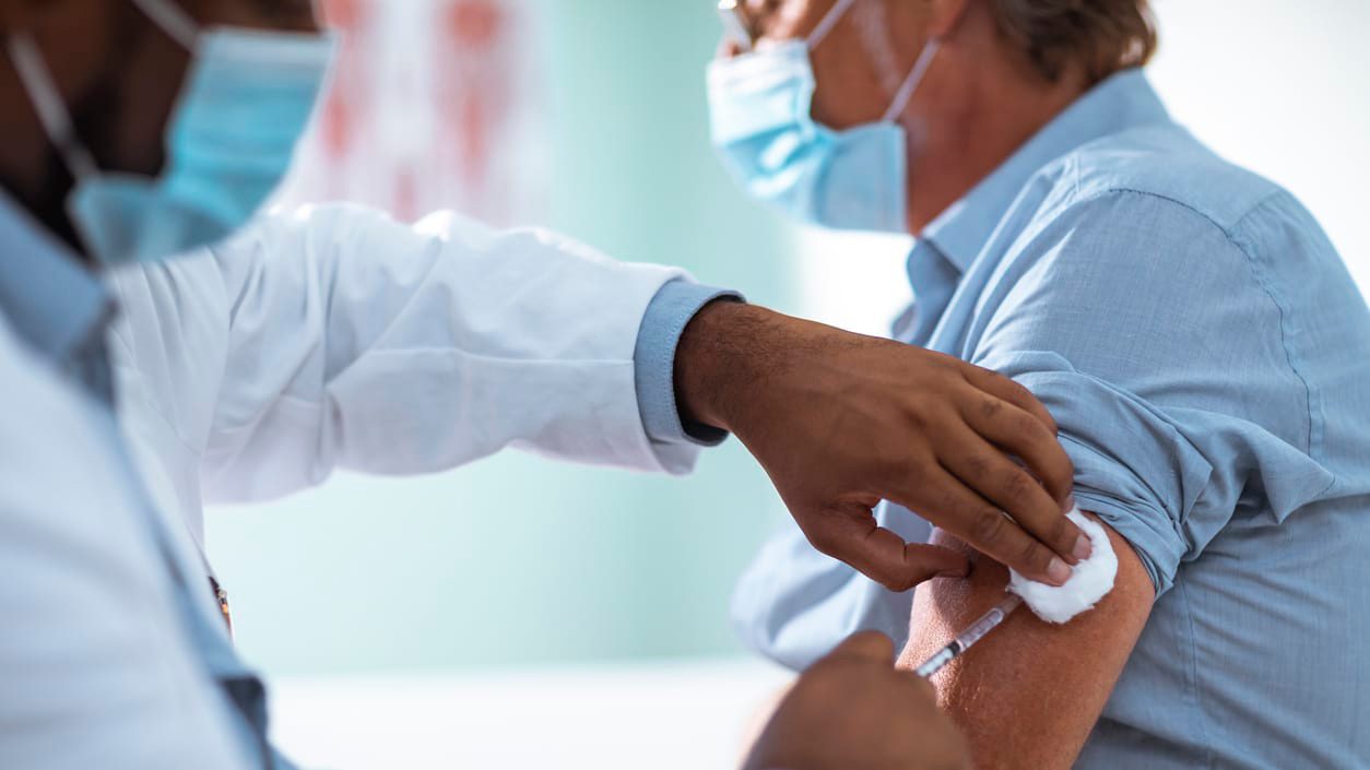 A doctor giving a shot to a patient.