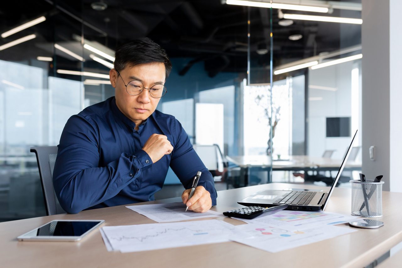 man in office looking at charts