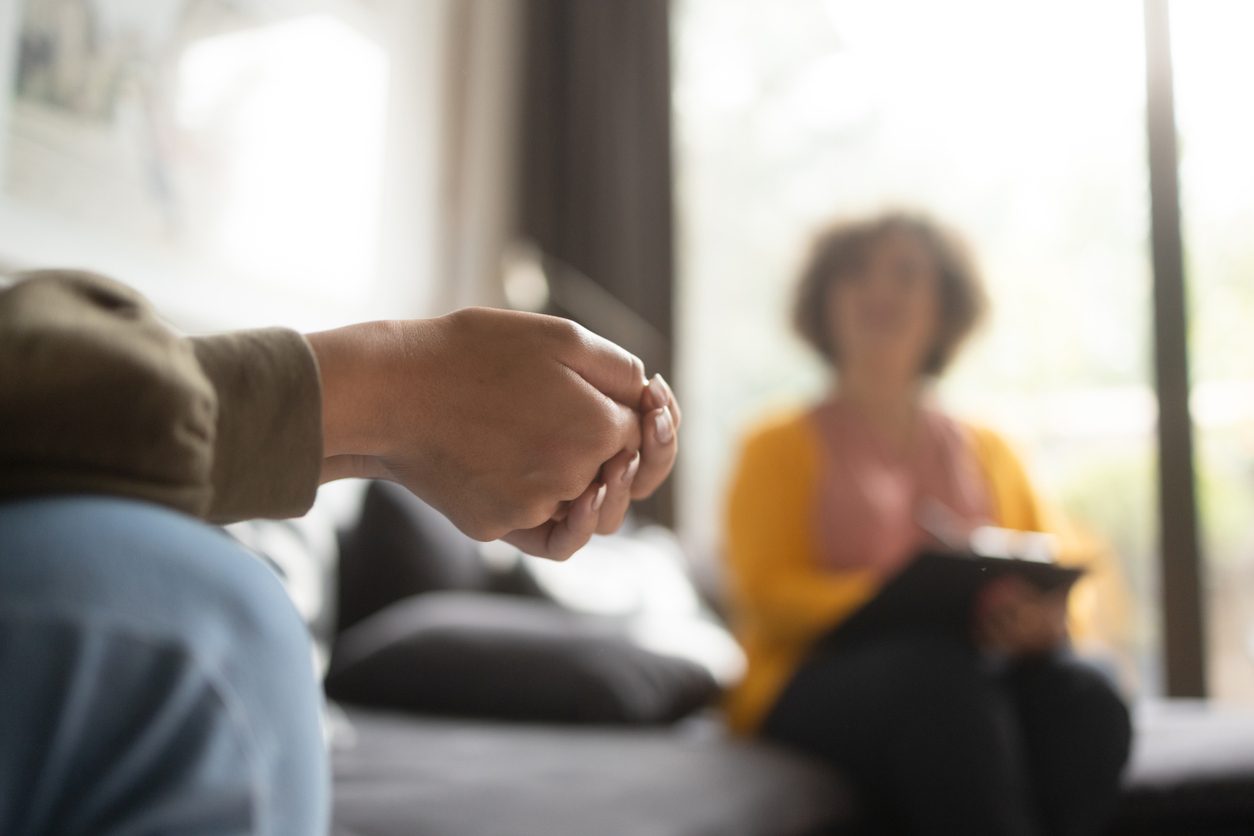 Close-up photo of a person's hands at a therapy session.