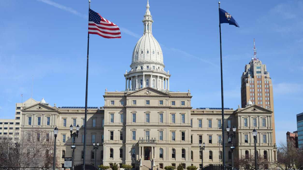 A building with two flags in front of it.