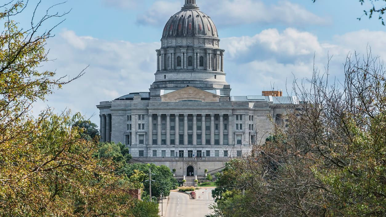 Idaho state capitol building with trees in the background.