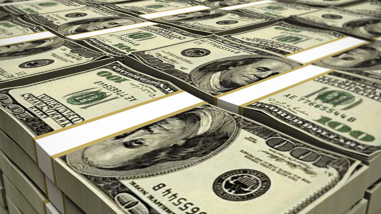 A pile of dollar bills stacked on top of each other.