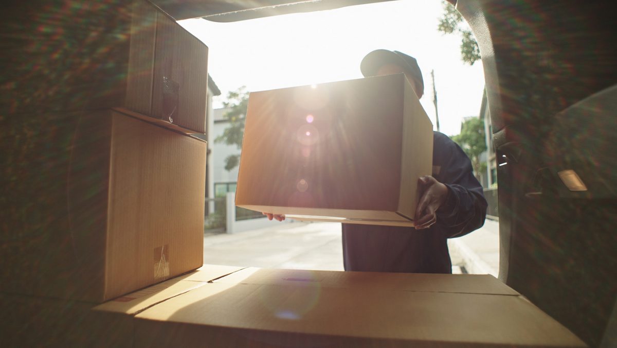 person loading boxes into a moving truck