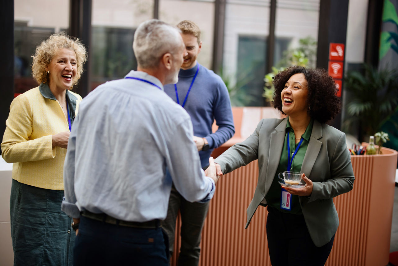 young woman networking at conference with coffee