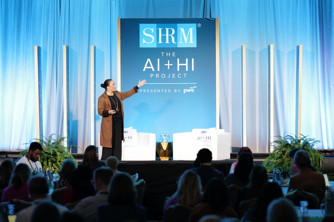 SHRM Executive in Residence for AI+HI Nichol Bradford on stage during the opening of The AI+HI Project 2026.