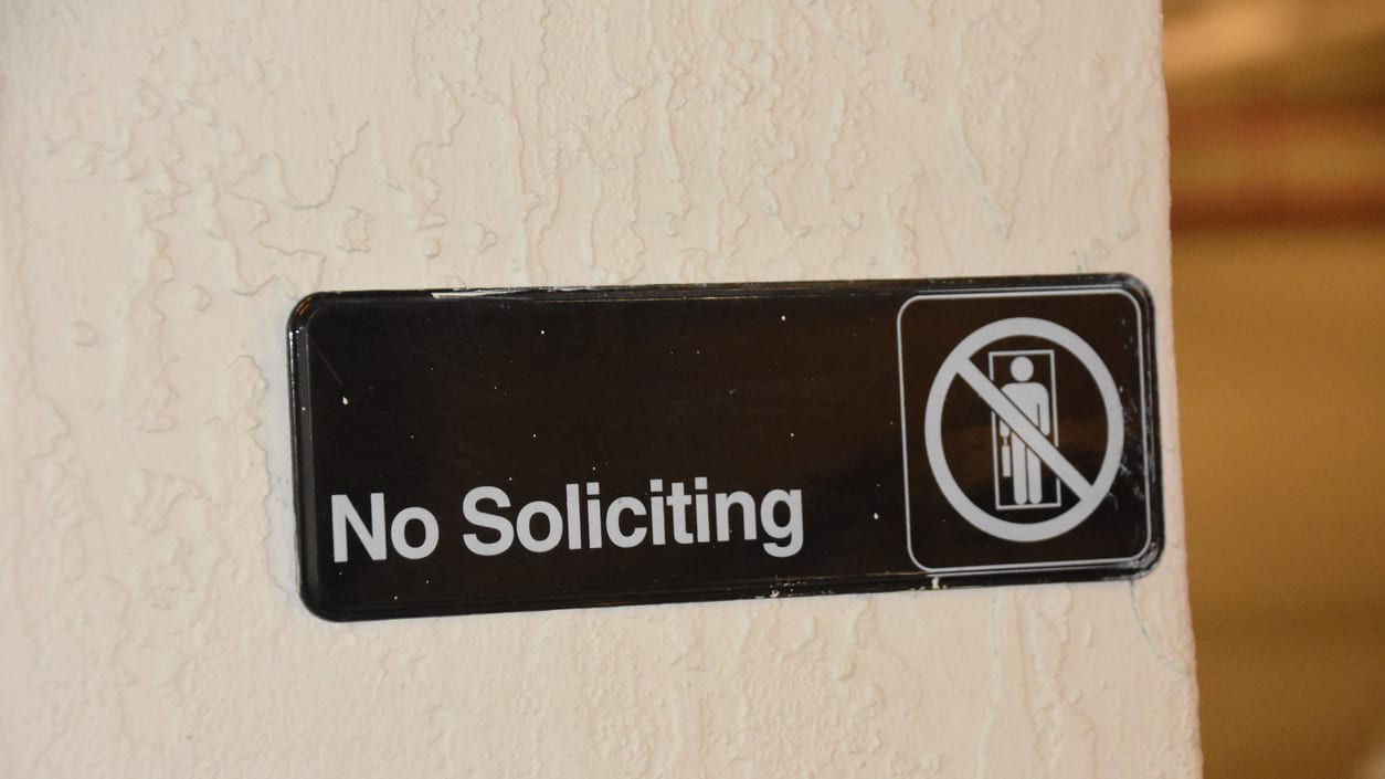 No soliciting sign on a door.