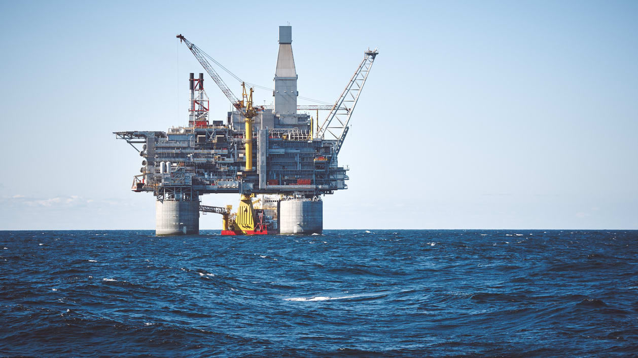 An oil rig in the middle of the ocean.