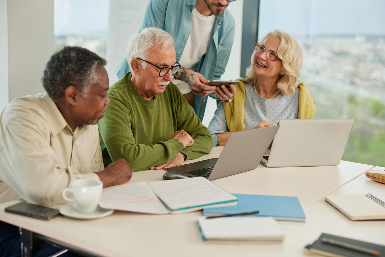 A small group of older workers in an office