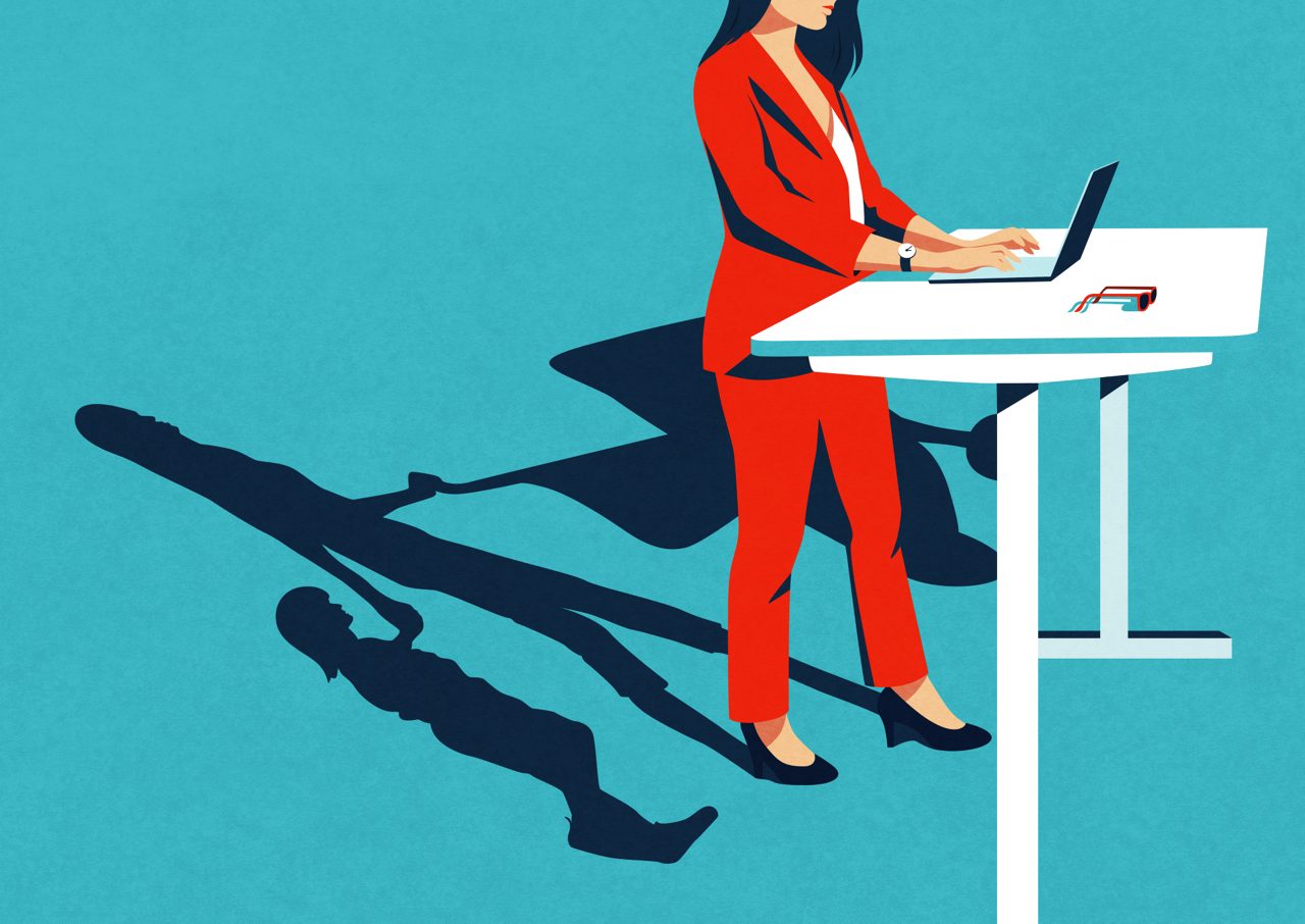 stylized drawing of a woman standing at a desk with laptop. her shadow behind her shows her pushing a baby carriage and holding a child's hand