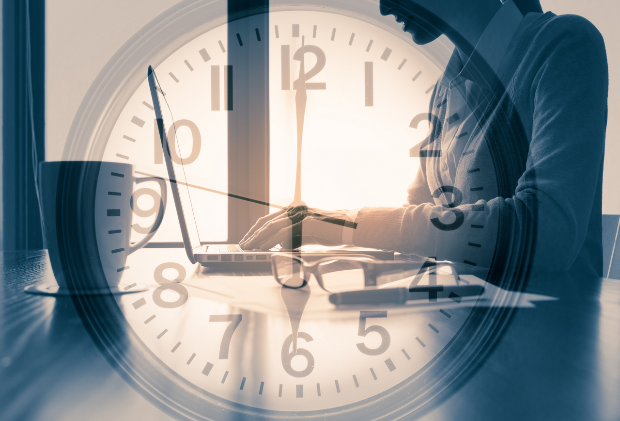 Illustration of clock face and person working on laptop after normal business hours
