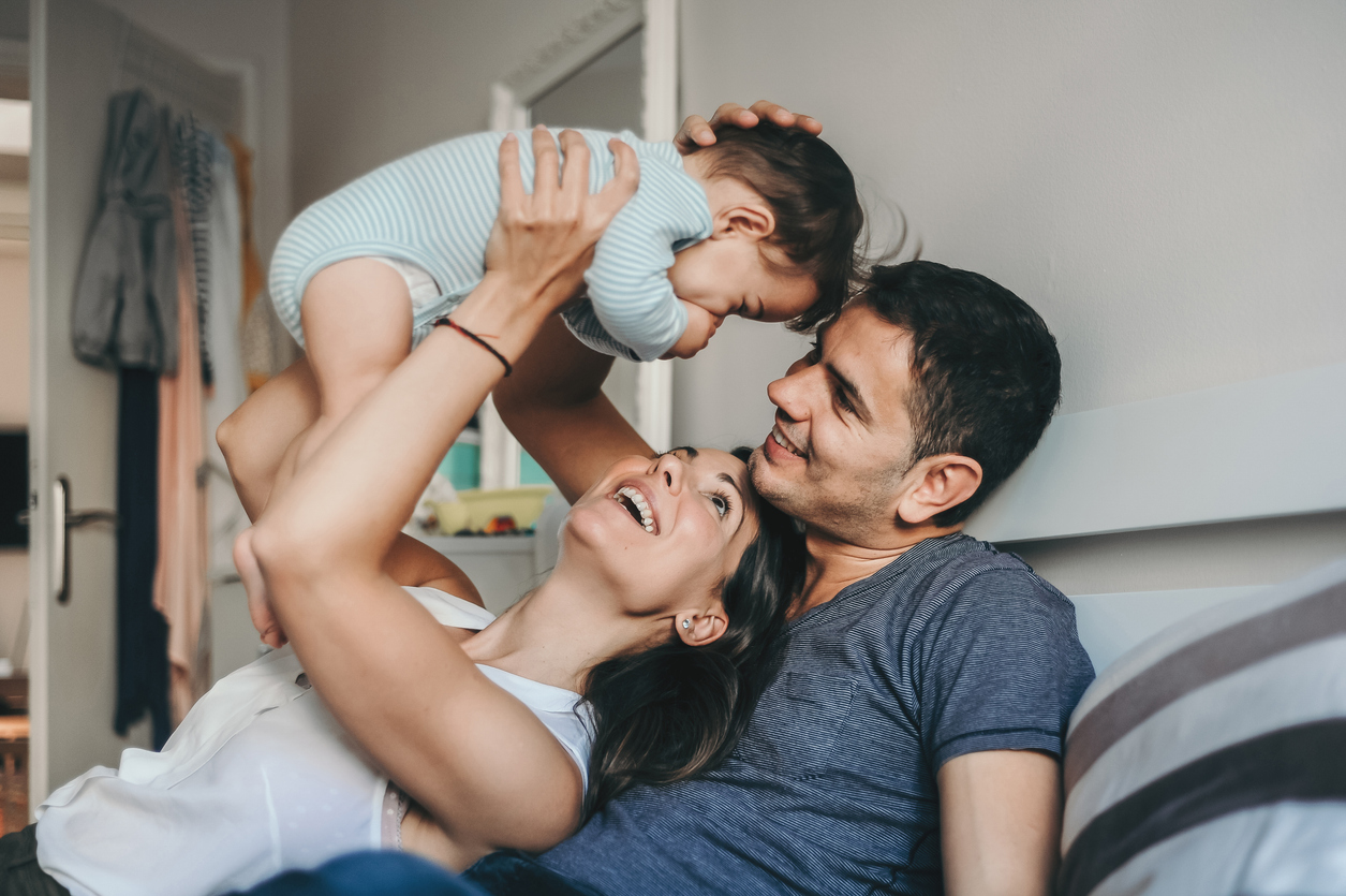 A joyful family enjoys quality time together at home, capturing the love and happiness they share.