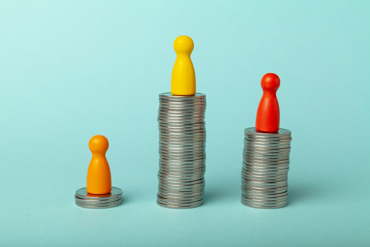 Pieces on stacks of coins, Concept of different levels of income and financial profit.