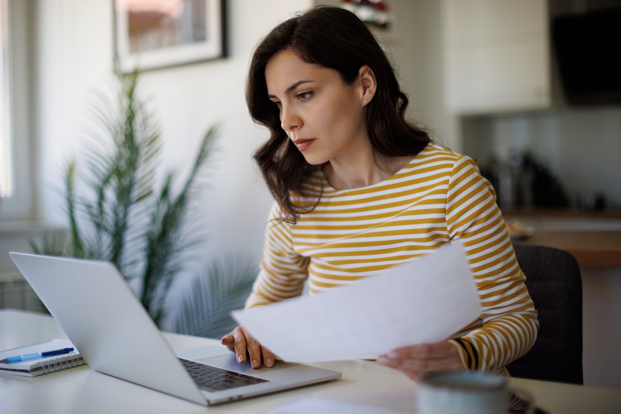 Serious young woman working at home