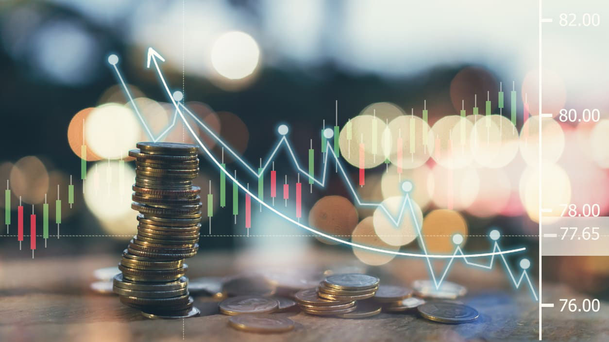 A stack of coins on a table with blurred background.