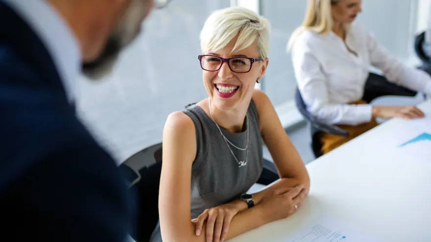 Woman smiling in an office meeting