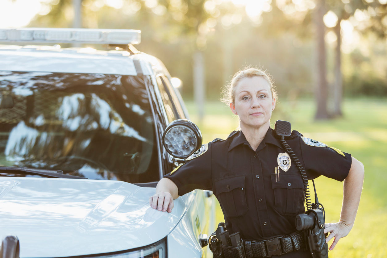 female police officer with car