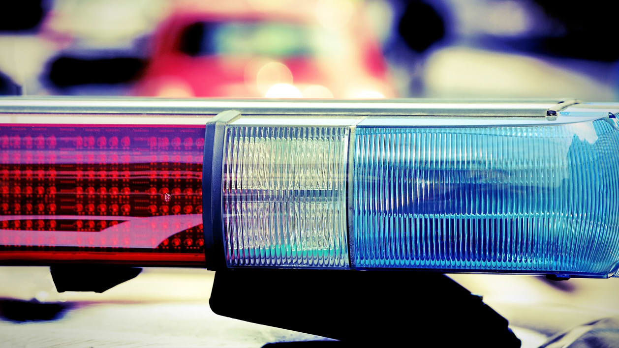 A police car with a blue and red light on it.