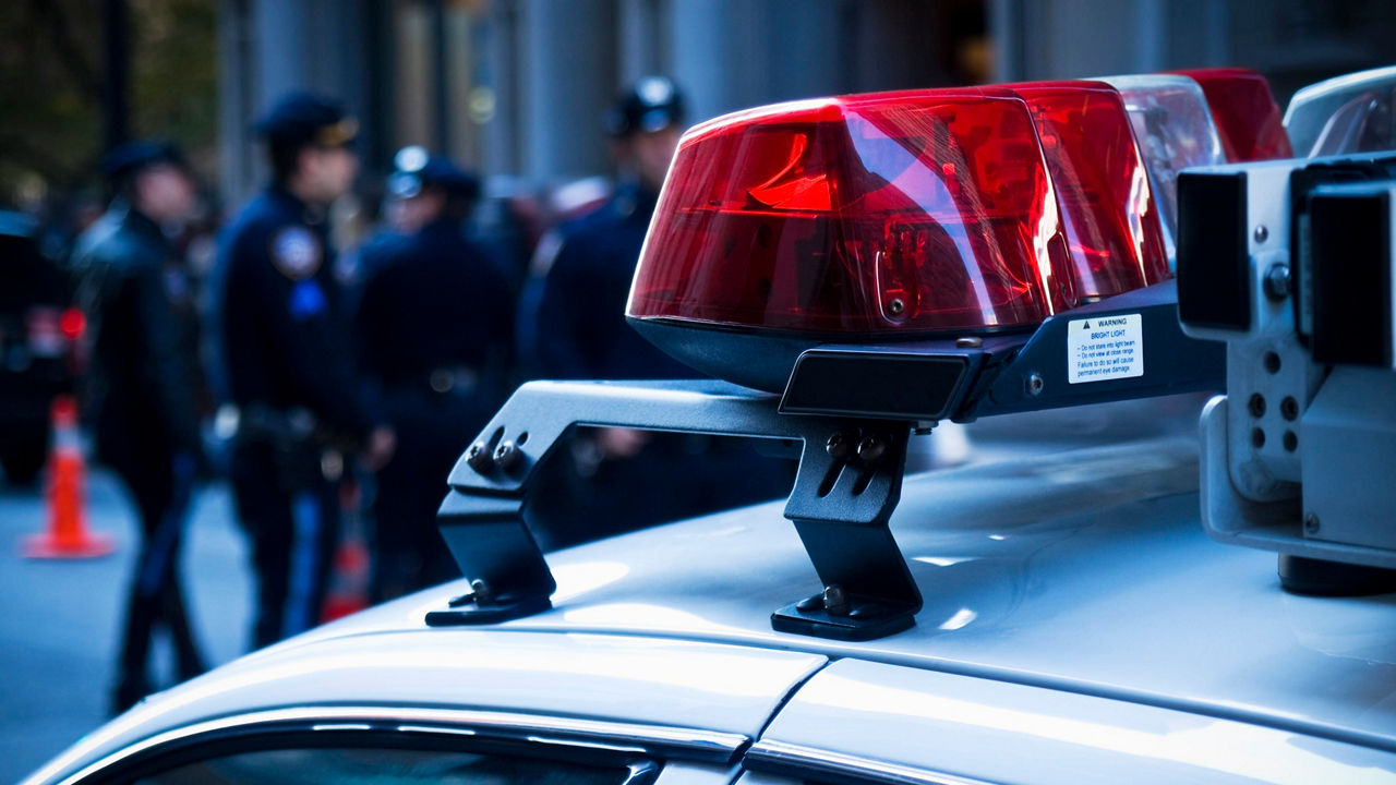 A police car with a red light on top.