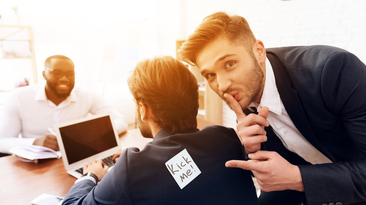 A man in a suit is pointing at a man in a suit.