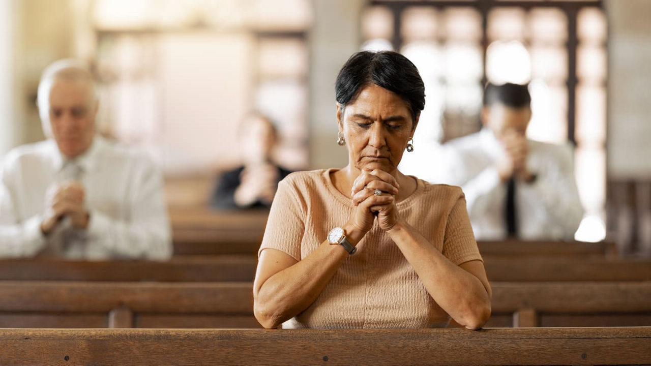 A woman praying in a church.
